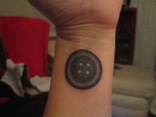 Black Ink Button Tattoo On Wrist