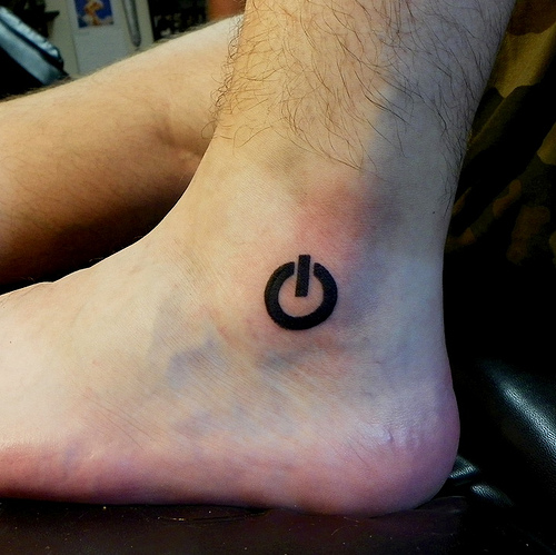 Black Power Button Tattoo On Ankle