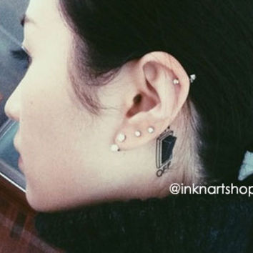 Black Switch Button Tattoo On Girl Behind The Ear