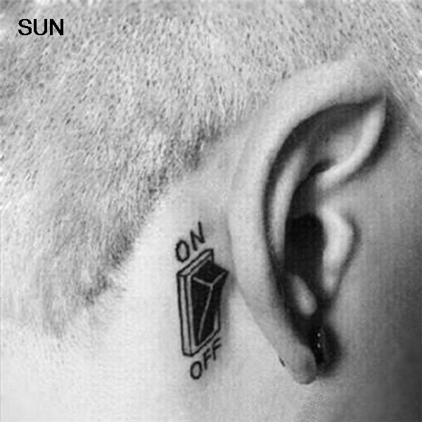 Black Switch Button Tattoo On Man Behind The Ear