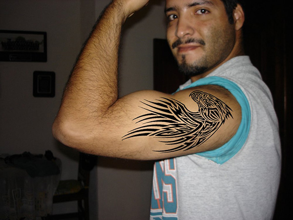 Black Tribal Eagle Head Tattoo On Man Left Bicep By Hector