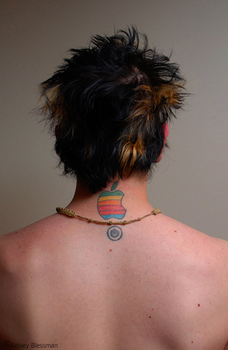 Colorful Apple Logo And Power Button Tattoo On Man Back Neck