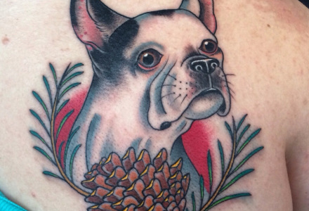 Cute puppy tattoo on back shoulder by Zack Spurlock