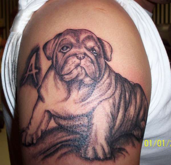 Cute realistic puppy portrait tattoo on shoulder