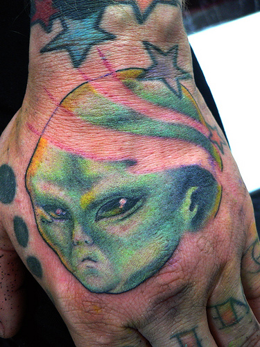Fat Alien Head Tattoo On Left Hand
