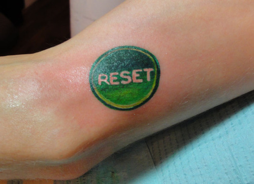Green Ink Reset Button Tattoo Design For Arm