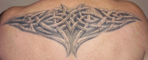 Grey Ink Merry Celtic Knot Tattoo On Man Upper Back