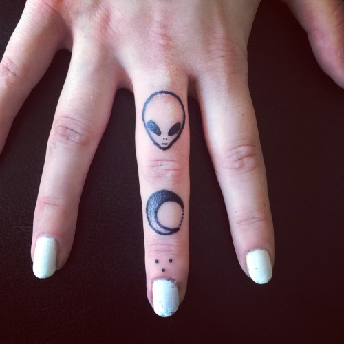 Grey Ink Moon And Small Alien Head Tattoo On Finger