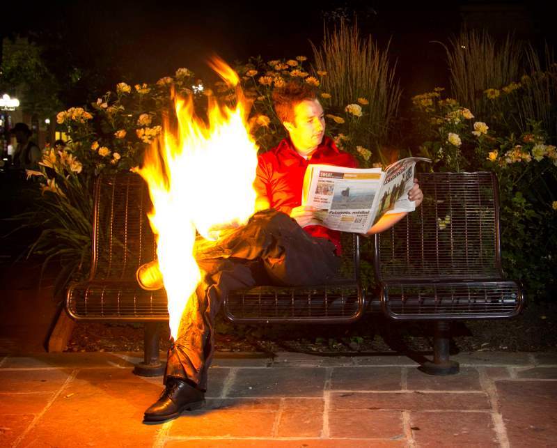 Man Reading Newspaper With Fire Legs Funny Picture