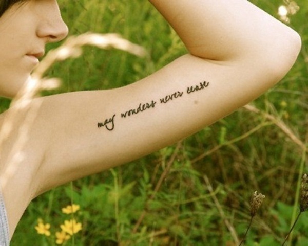 May Wonders Never Cease Lettering Tattoo On Girl Left Bicep