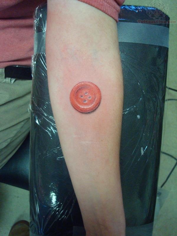 Orange Ink Button Tattoo On Forearm