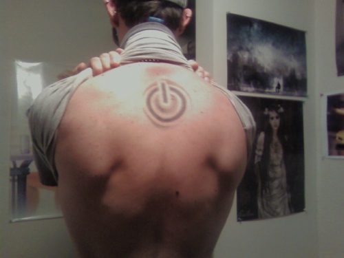 Power Button Tattoo On Man Upper Back