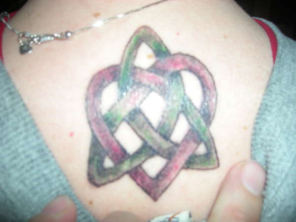 Red And Green Celtic Love Knot Tattoo On Upper Back
