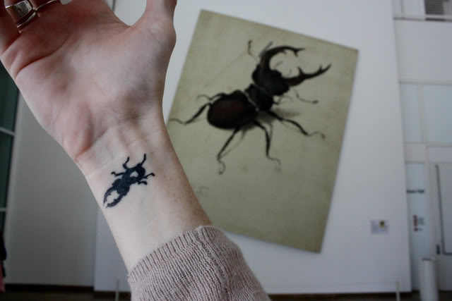 Silhouette Beetle Tattoo On Wrist