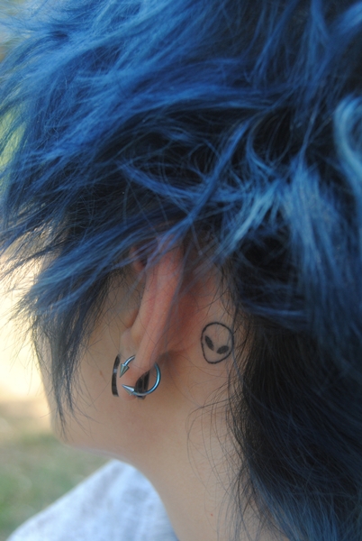 Small Alien Head Tattoo Behind Ear