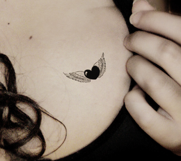 Small Heart With Angel Wings Tattoo on Chest