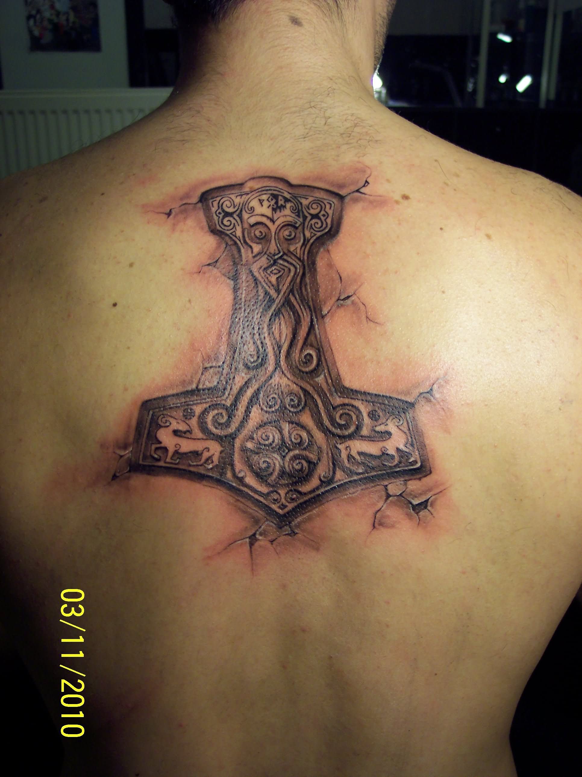 Amazing Ripped Skin Thor Hammer Symbol Tattoo On Man Upper Back