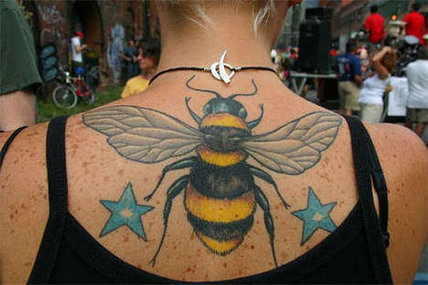 Awesome Bumblebee With Stars Tattoo On Girl Upper Back By Bluheart