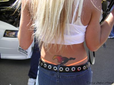 Awesome Colorful Mustang Tattoo On Girl Lower Back