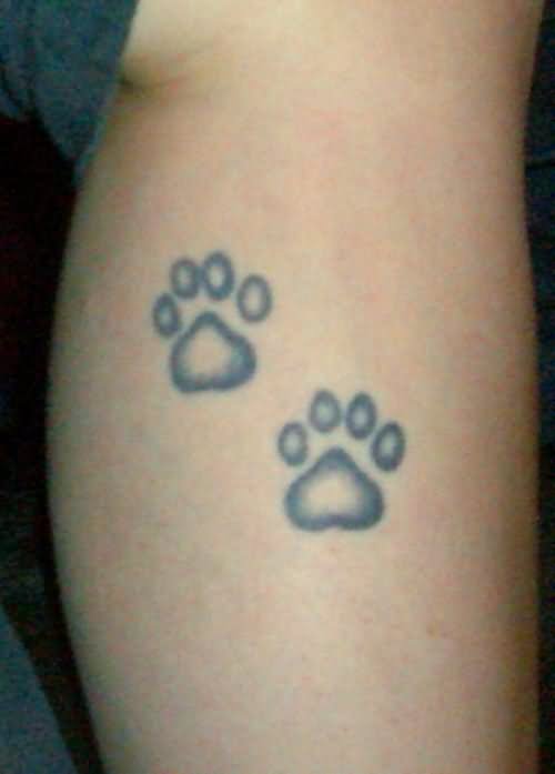 Black And Grey Ink Puppy Paw Tattoo On Leg
