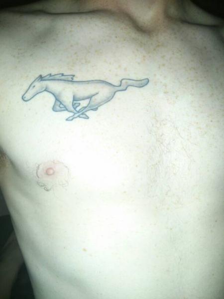 Black And Grey Mustang Tattoo On Man Chest