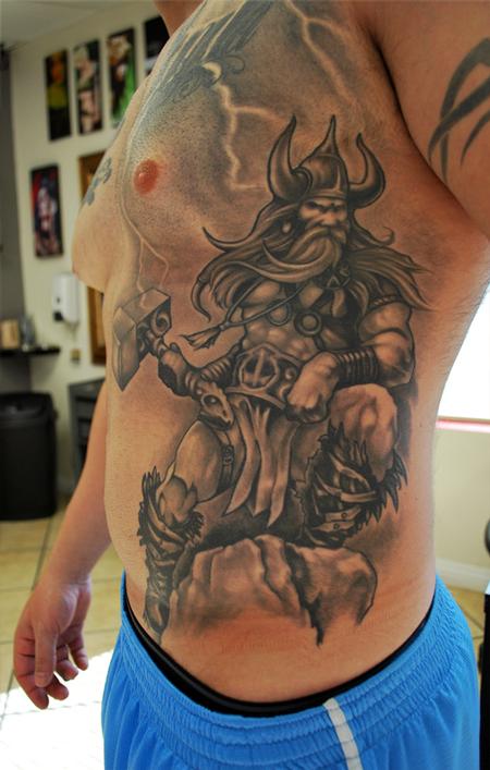 Black And Grey Thor Tattoo On Man Side Rib