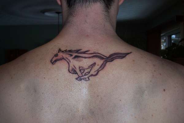 Black Ink Mustang Tattoo On Man Upper Back