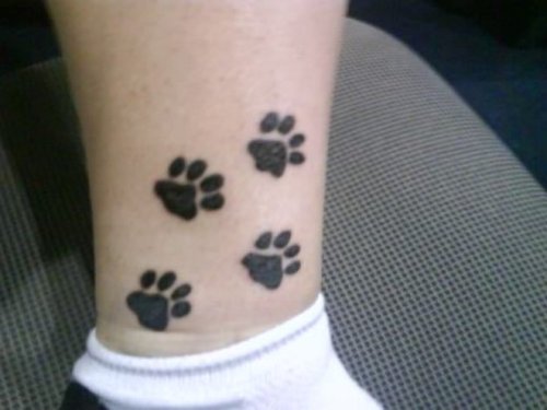 Black Ink Paw Tattoos On Leg