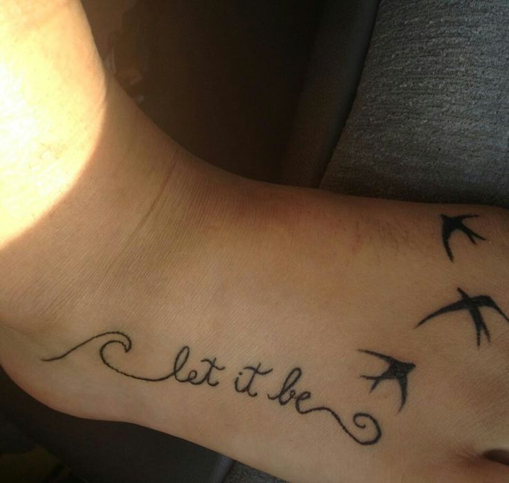 Black Outline Wave With Let It Be Lettering And Flying Birds Tattoo On Foot