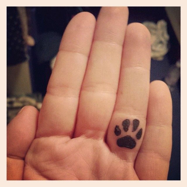 Black Puppy Paw Tattoo On Finger
