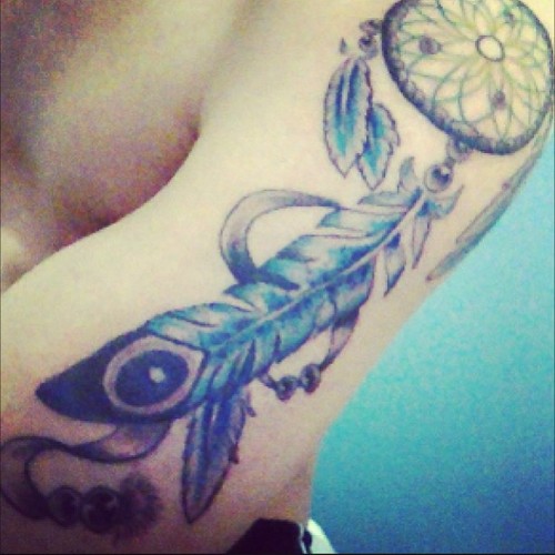 Blue Ink Dreamcatcher Tattoo On Man Left Arm