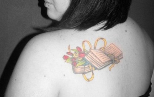 Book With Flowers Tattoo On Girl Left Back Shoulder