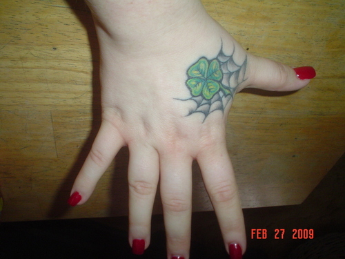 Four Leaf With Web Tattoo On Girl Hand