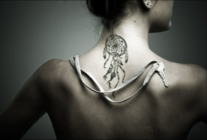 Girl Showing Her Dreamcatcher Tattoo On Upper Back