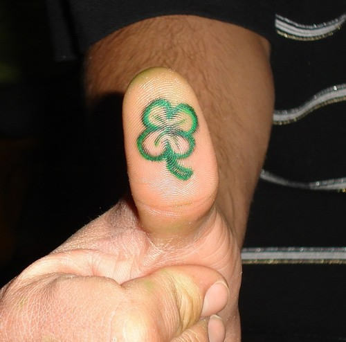Green Four Leaf Tattoo On Under Thumb