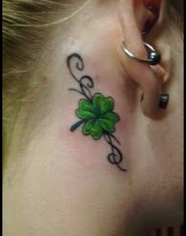 Green Ink Four Leaf Tattoo On Girl Behind The Ear