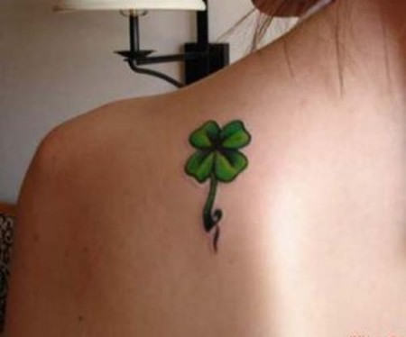 Green Ink Four Leaf Tattoo On Girl Left Back Shoulder