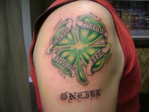 Green Ink Four Leaf With Banner Tattoo On Right Shoulder