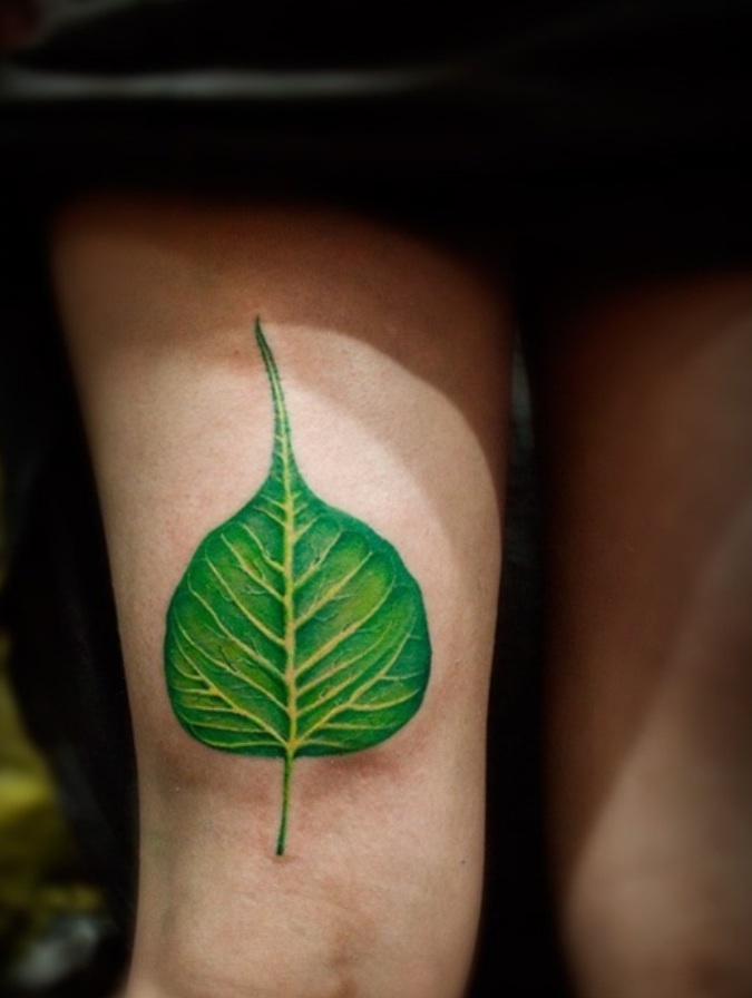 Green Peepal Leaf Tattoo On Girl Right Thigh