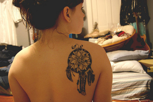 Grey Flower In Black Dreamcatcher Tattoo On Back