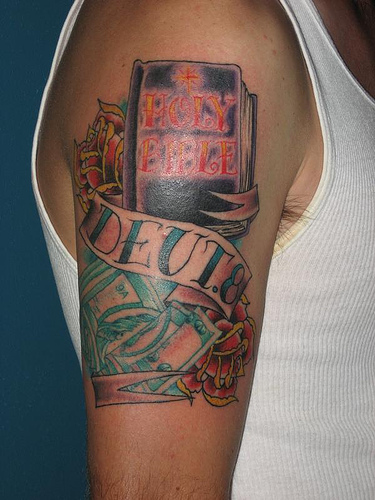 Holy Bible Book With Banner Tattoo On Man Right Shoulder