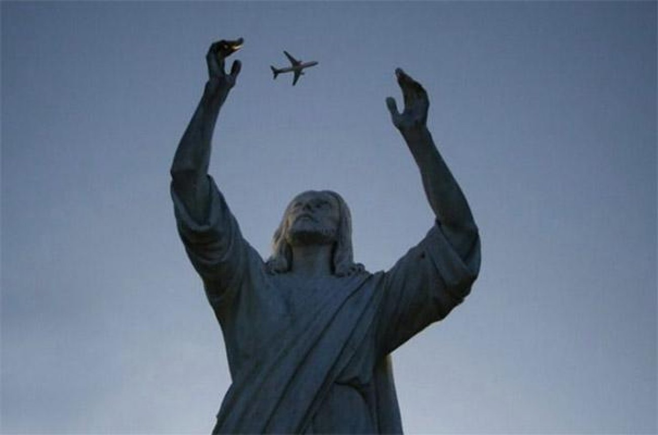 Jesus Statue Trying To Catch Plane Funny Unusual Angle Picture