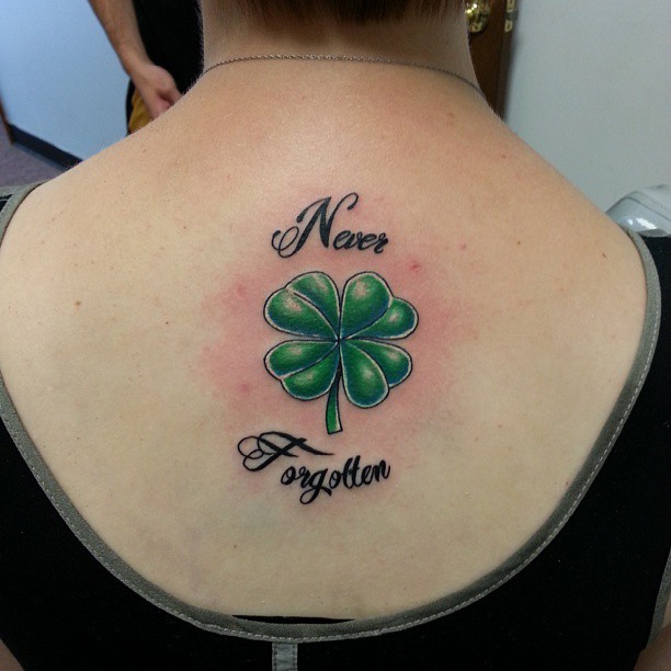 Never Forgotten – Four Leaf Tattoo On Girl Upper Back
