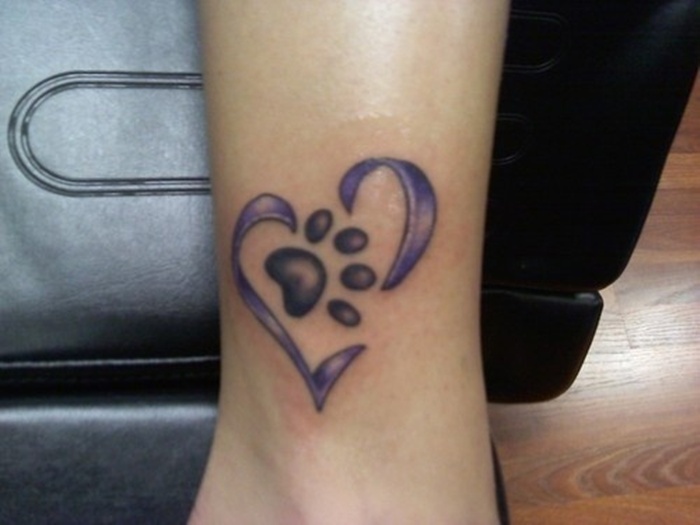 Purple Ink Heart And Grey Puppy Paw Tattoos On Leg