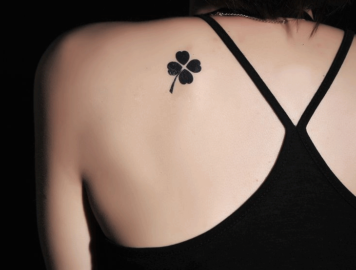 Silhouette Four Leaf Tattoo On Girl Left Back Shoulder