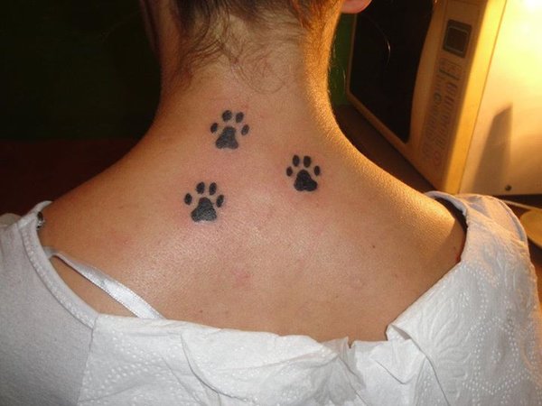 Small Black Ink Puppy Paw Tattoos On Upper Back