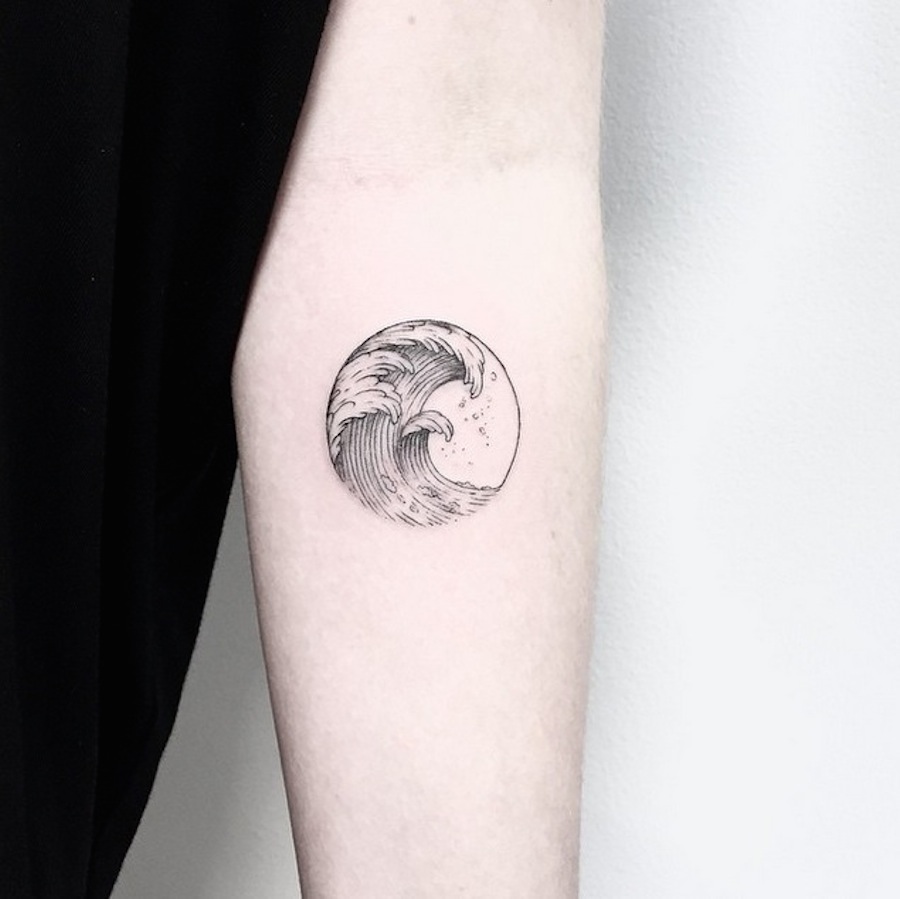 Wave In Circle Frame Tattoo On Forearm