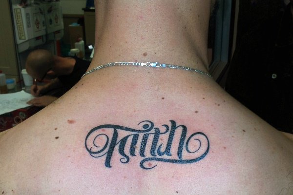 Ambigram Faith Lettering Tattoo On Man Upper Back