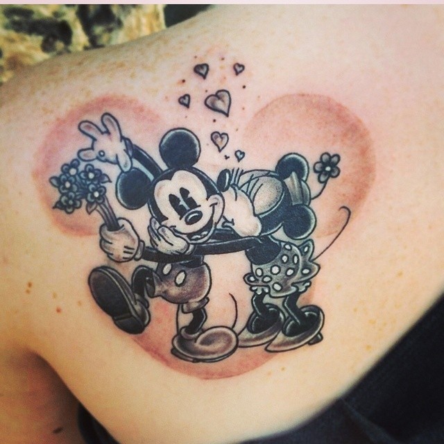 Black And Grey Mickey Mouse And Minnie Mouse Tattoo On Left Back Shoulder
