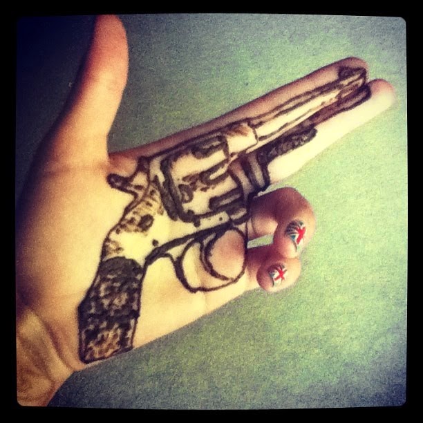 Black Gun Tattoo On Girl Hand Palm